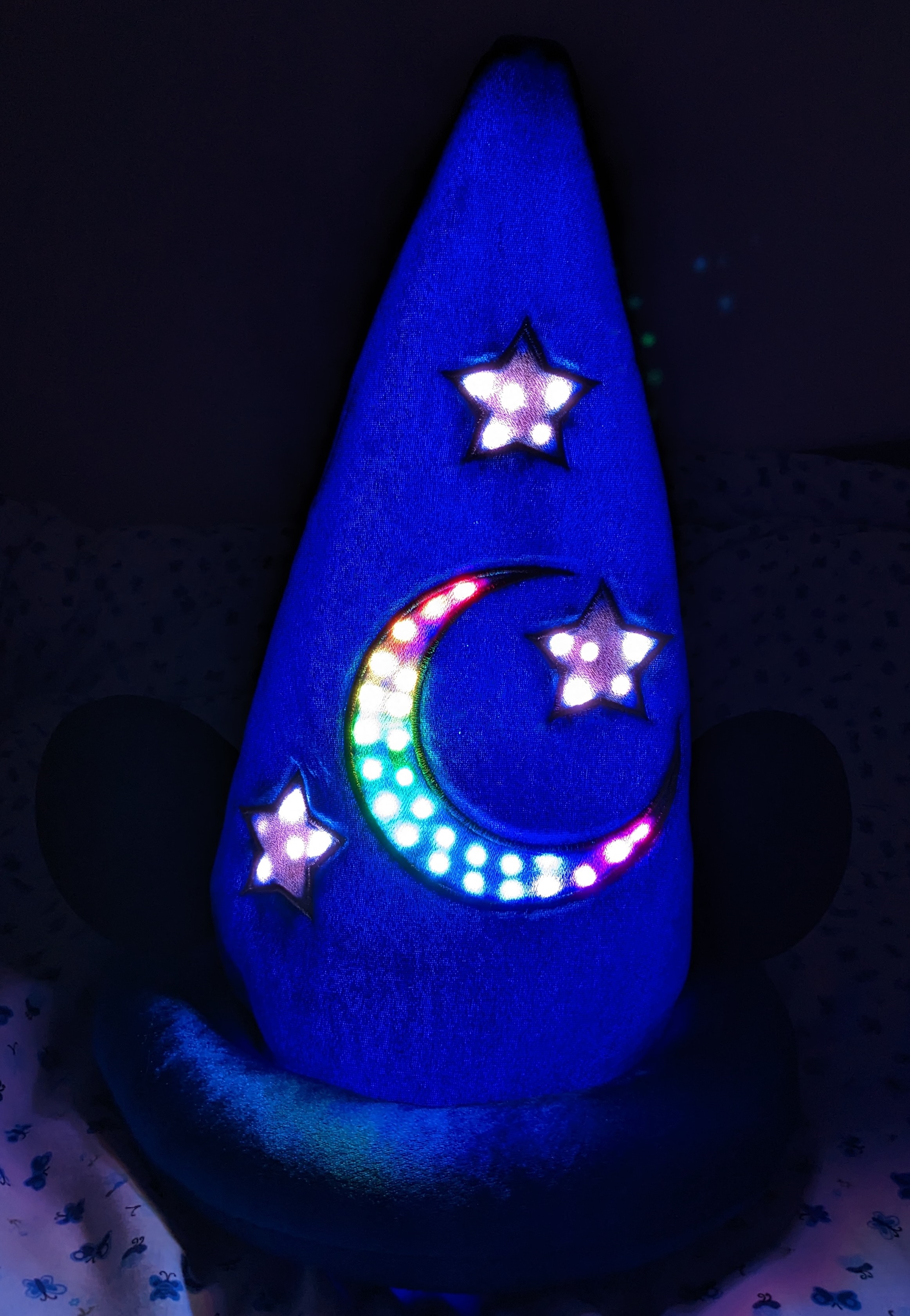 Illuminated sorcerer hat in a dark room
